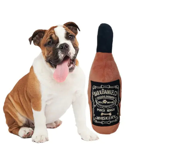 dog pictured next to whiskey play toy, white background