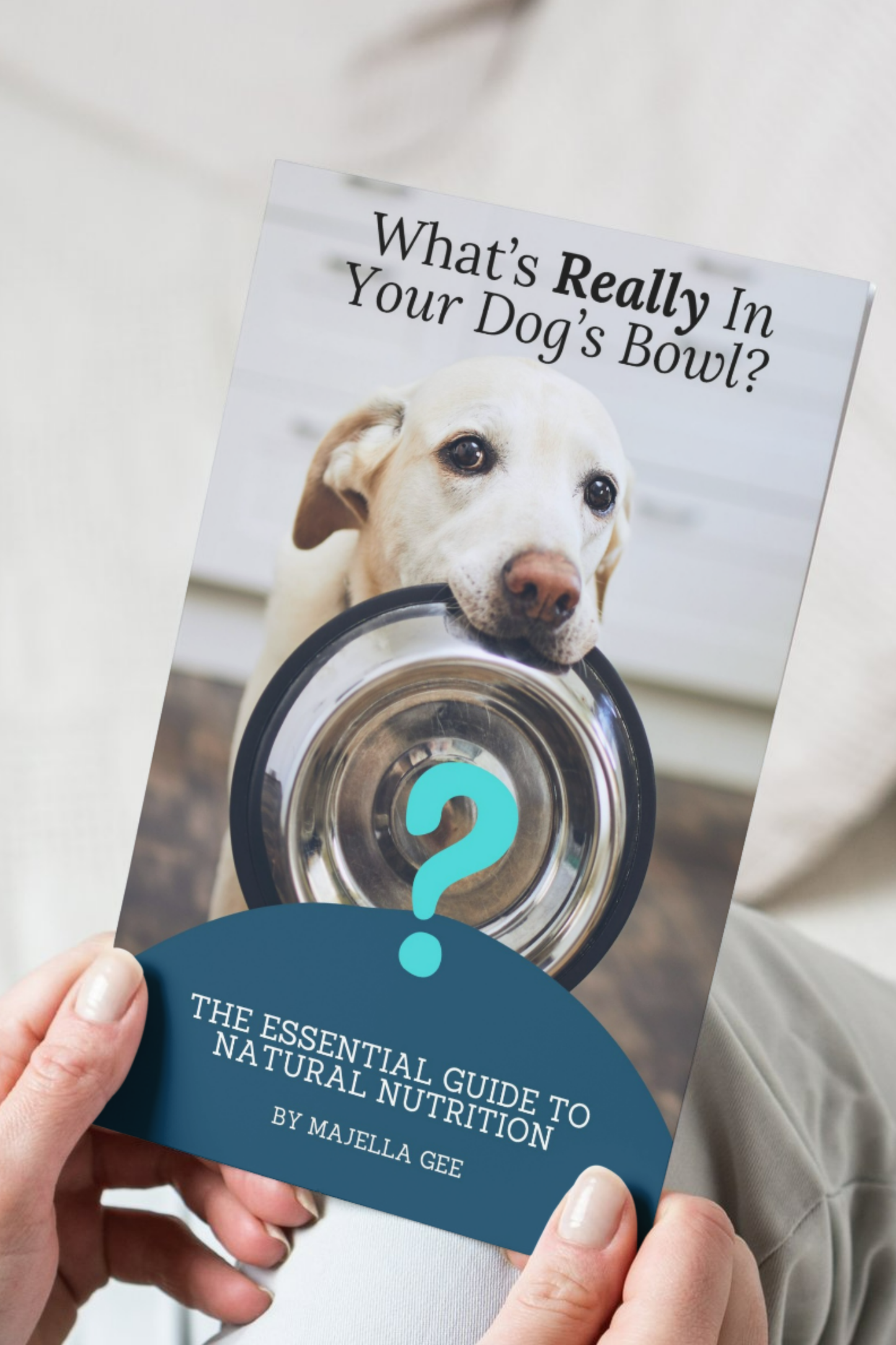 Hands holding the book - What's Really in Your Dog's Bowl.