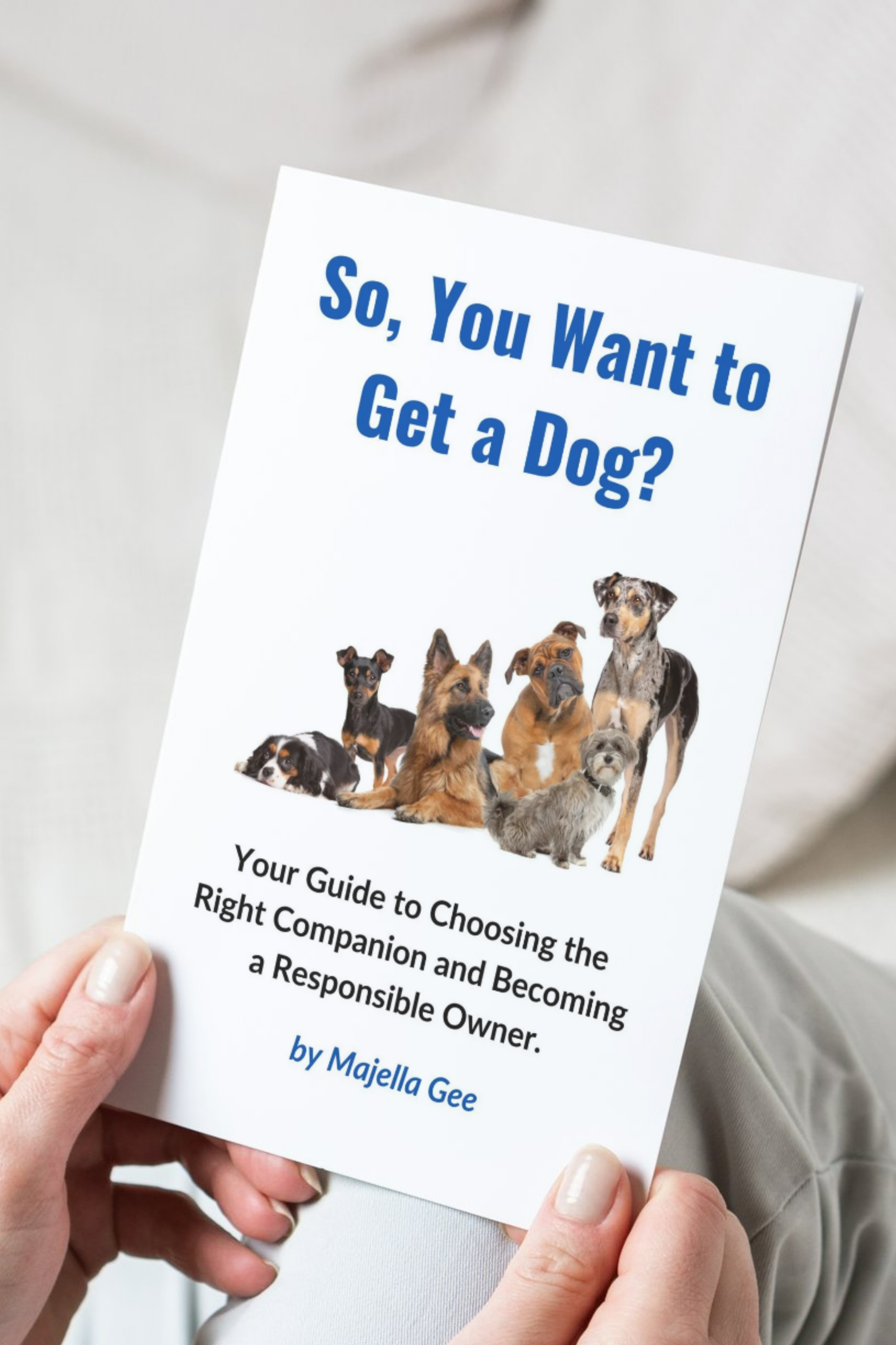Hand holding the book - So, You Want to Get a Dog?