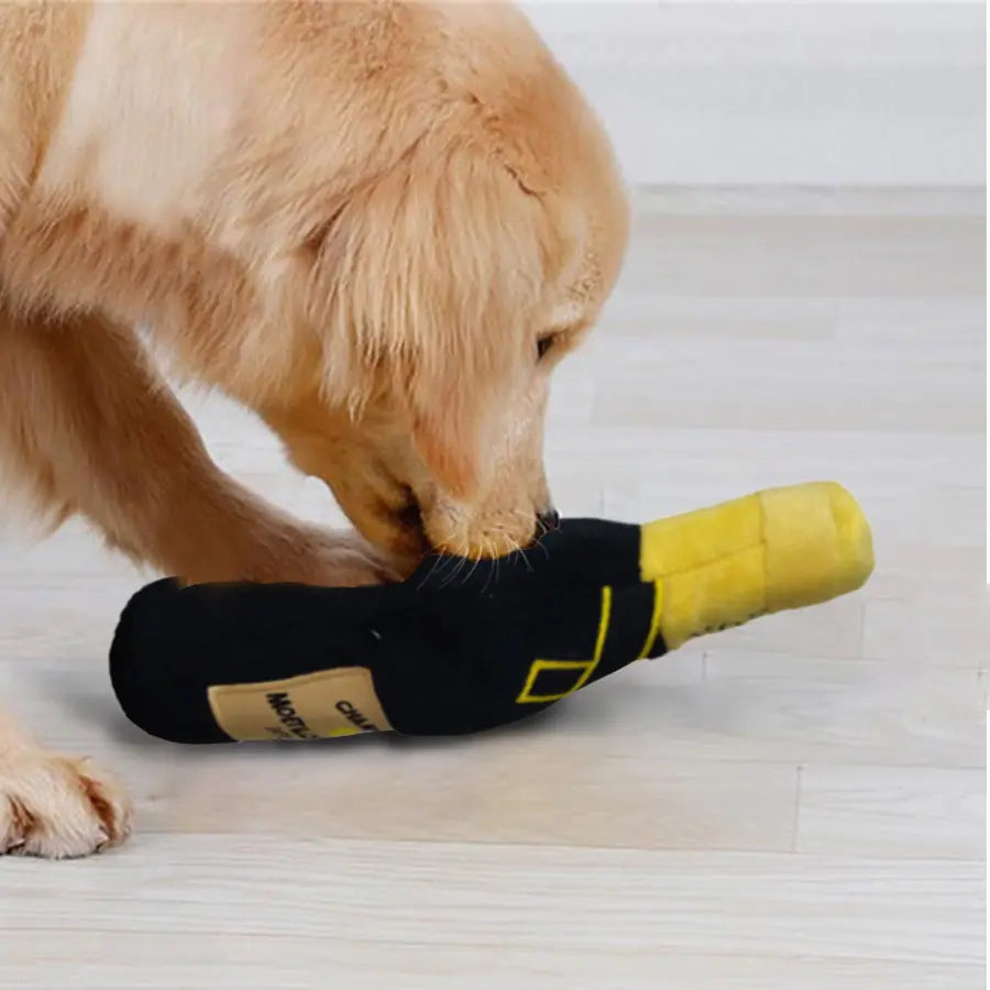 dog playing with a champagne bottle toy in a home setting.