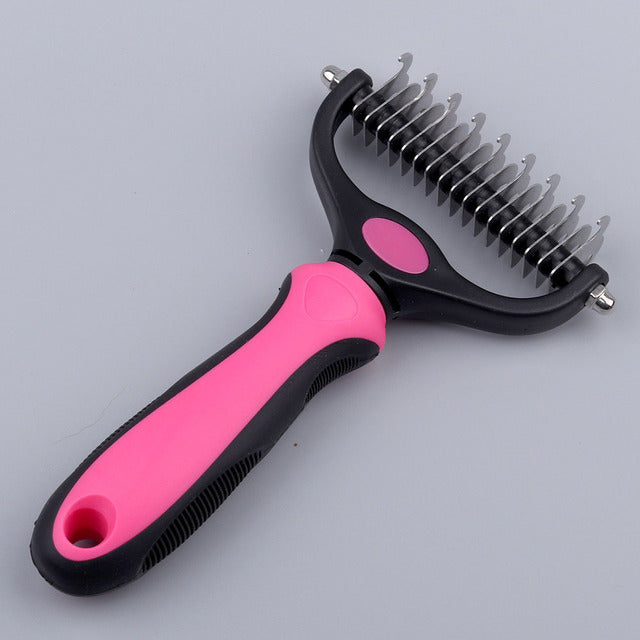 pink and black grooming comb on white background, showing curved blades. 