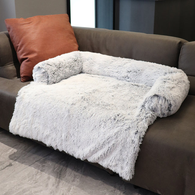 Light grey sofa bed on a brown couch in a home setting