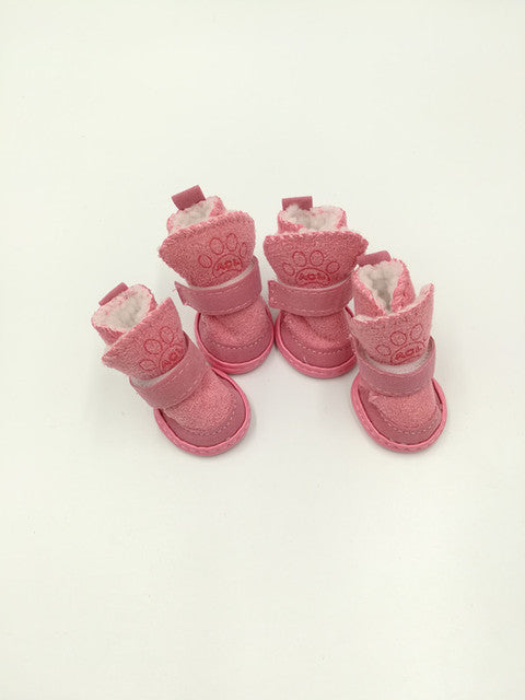 set of pink snow boots on white background. 