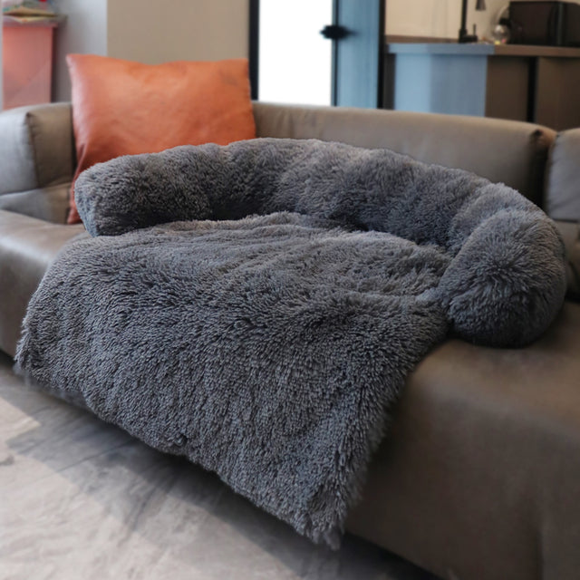 dark grey sofa on a coach in a home setting. 