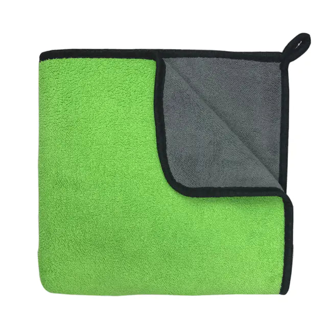 Green towel with reverse side showing color contrast. white background. 