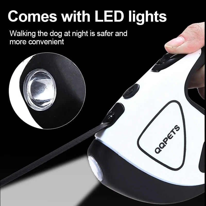 A white Retractable Dog Leash on a black background, a human thumb presses the switch for the LED light, which is shown in a close up inset image. 