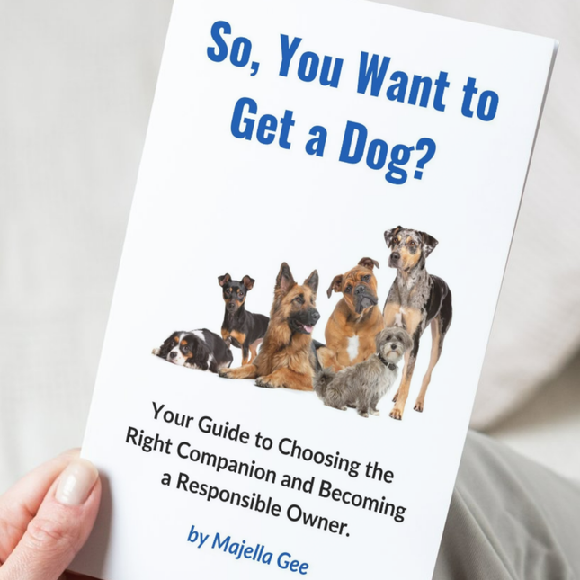 Hand holding the book - So, You Want to Get a Dog? 