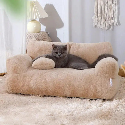 Grey cat lounges on an apricot luxe pet sofa in a home setting 