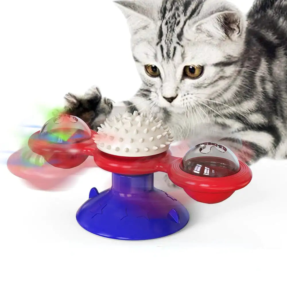 A grey tabby cat interacts with a Red and Blue Purrfect Spin-N-Twist Cat Toy on a white background