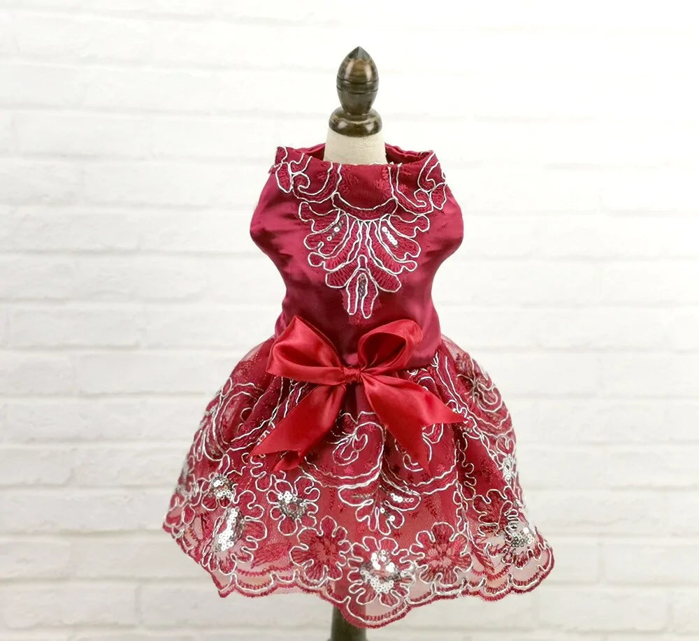 Red Glamour Princess Party Dress on a stand, white brick background 