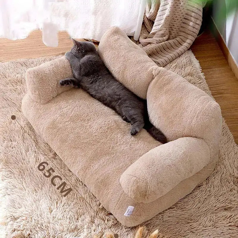 Grey cat lounges on an apricot luxe pet sofa in a home setting , length of sofa 65 cms is displayed. 