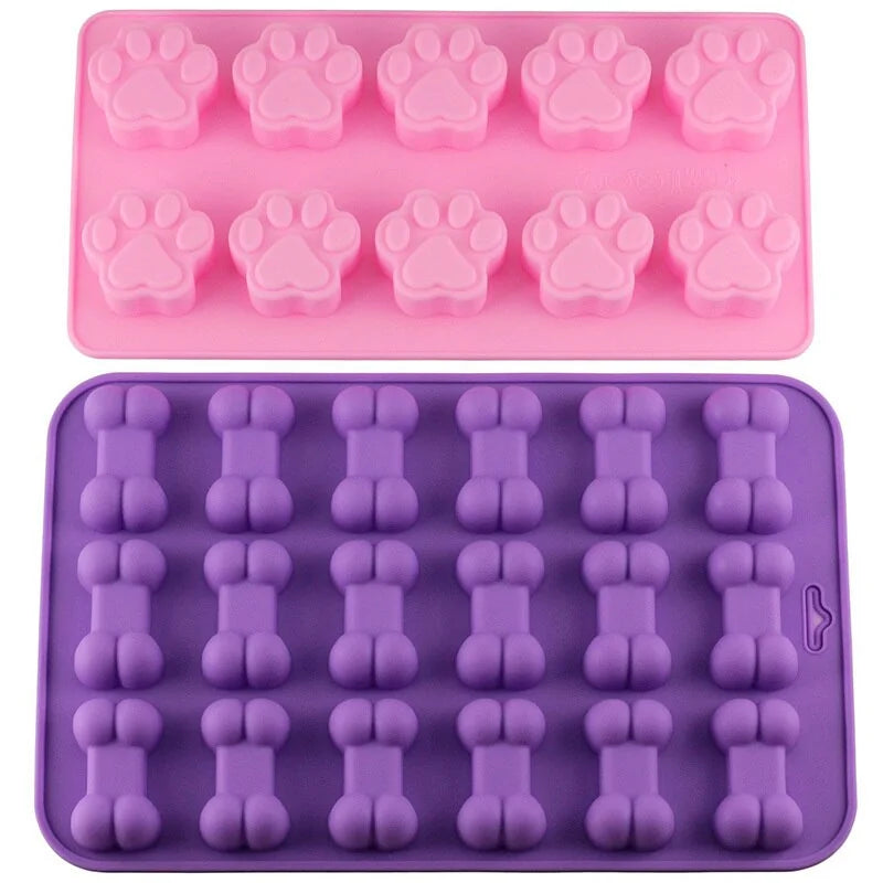 Paw and Bone Treat Molds on a white background. Bone shaped mold is purple and paw shaped mold is pink. 