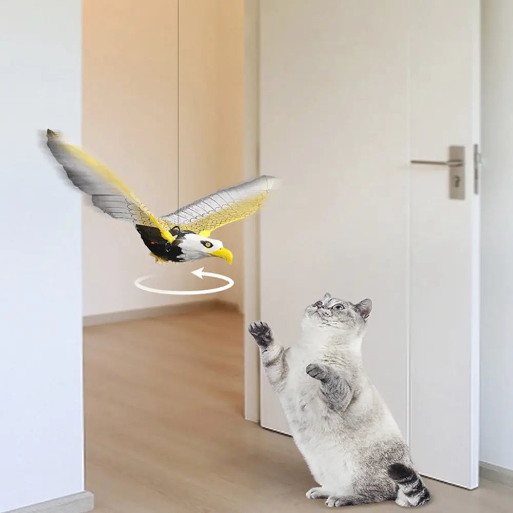 Eagle design Flapping bird toy swings above a grey and white cat, in a home setting. Directional arrows show the bird moves. 