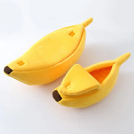 size comparison of a small and large banana shaped pet bed next to each other on a white background. 