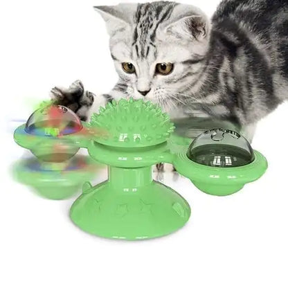 A grey tabby cat interacts with a Green Purrfect Spin-N-Twist Cat Toy on a white background