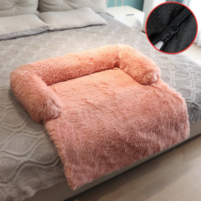 Apricot sofa bed in a bedroom setting, the sofa bed is positioned at the base of the bed, a smaller inset image shows the zipper, for easy cleaning. 