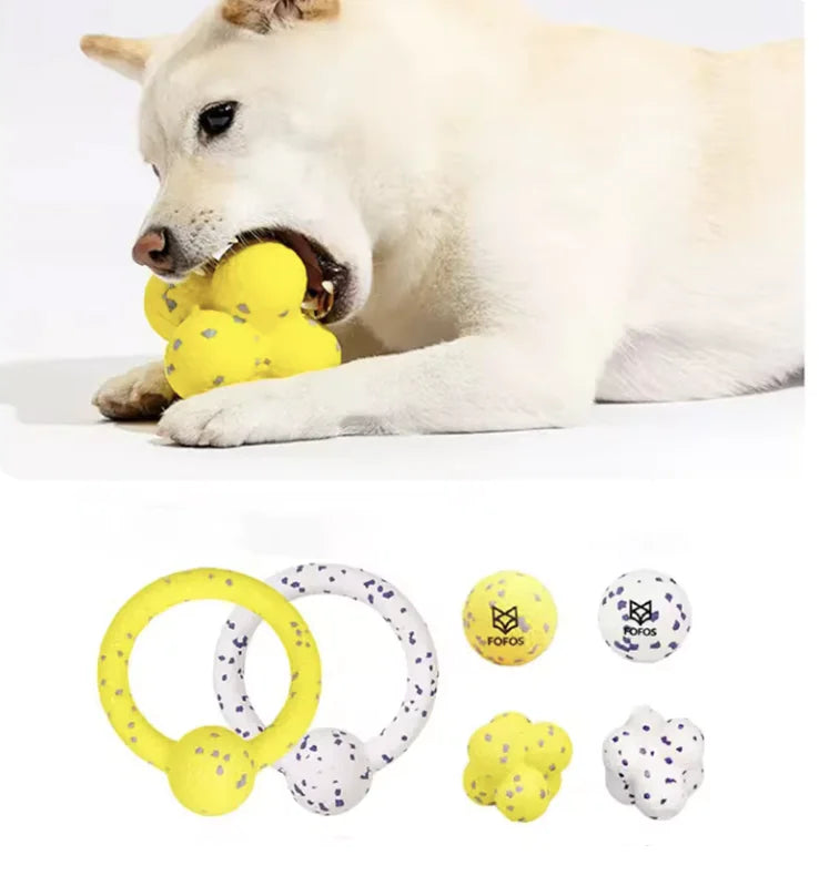 a white dog chews a yellow loop ball on a white background, inset shows different designs. 