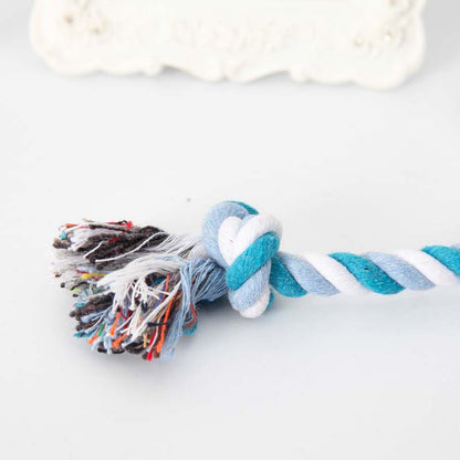 close up of the knot on a blue and white rope toy, white background