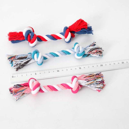 three different colored rope toys next to a ruler showing length of toy on white background