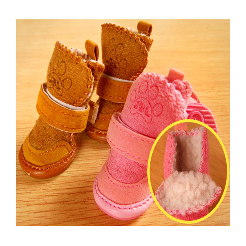 Brown and pink snow boots displayed  on a wooden surface. Inset shows inside view of the snow boot. 