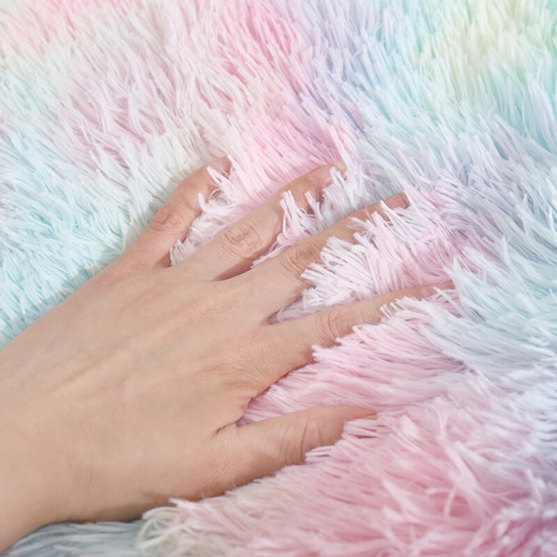 close up shot of a hand rubbing the soft texture of the bed. 