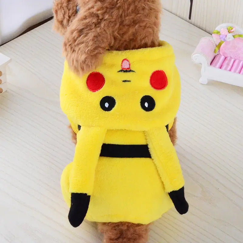 back view of small brown dog wearing yellow Pikachu costume in a home setting. 