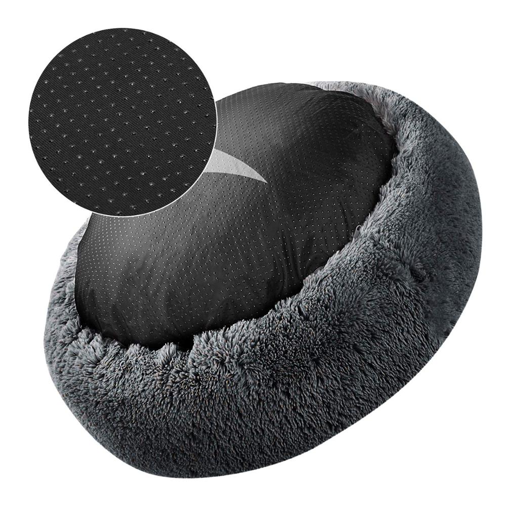 dark grey donut bed shown on a white background upside down, to show non-slip base. 