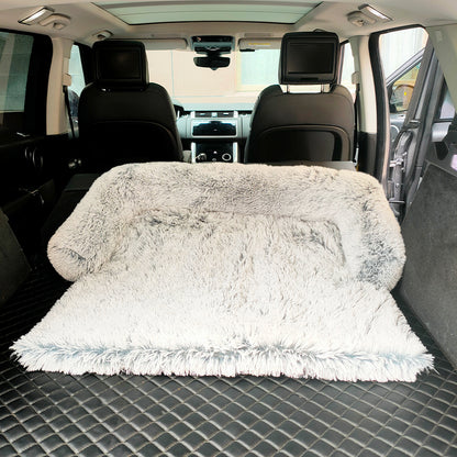 Light colored sofa shown in the back of a vehicle. 