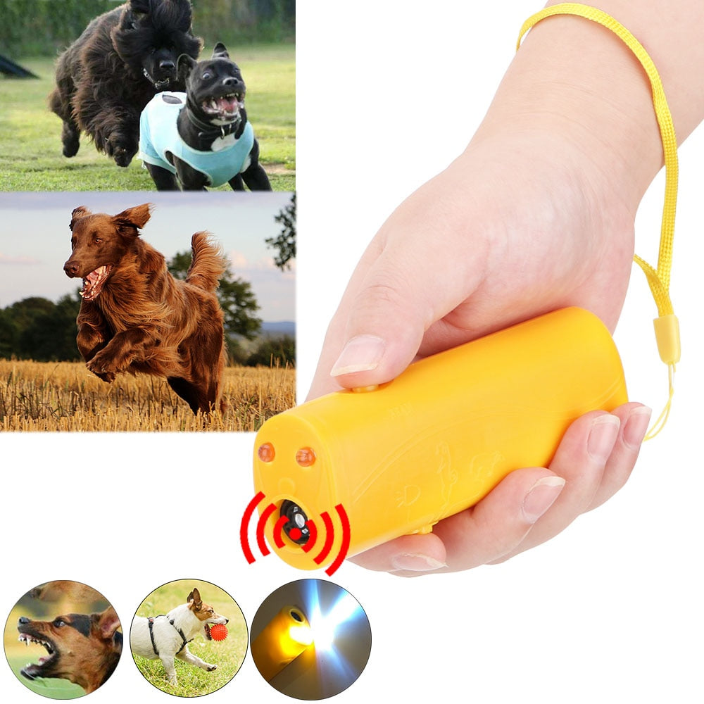 white background. main image shows a yellow device in hand, with thumb positioned on function key, yellow wrist band around the wrist. two insets of dogs playing in outdoor settings. three smaller insets show a dog barking, a dog playing and the torch function of the device. 