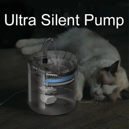 dark image depicting night time, with cat asleep on the floor next to the water fountain, text reads ultra silent pump