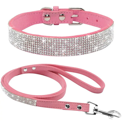 Pink rhinestone pet collar and leash set on white background. 