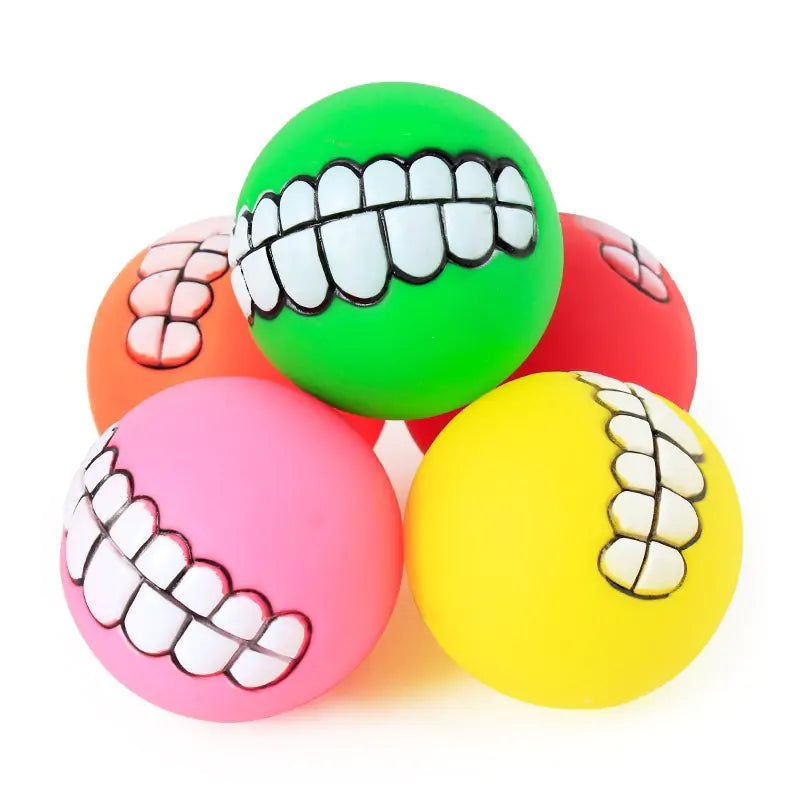 a group of five different colored smile balls on a white background. 