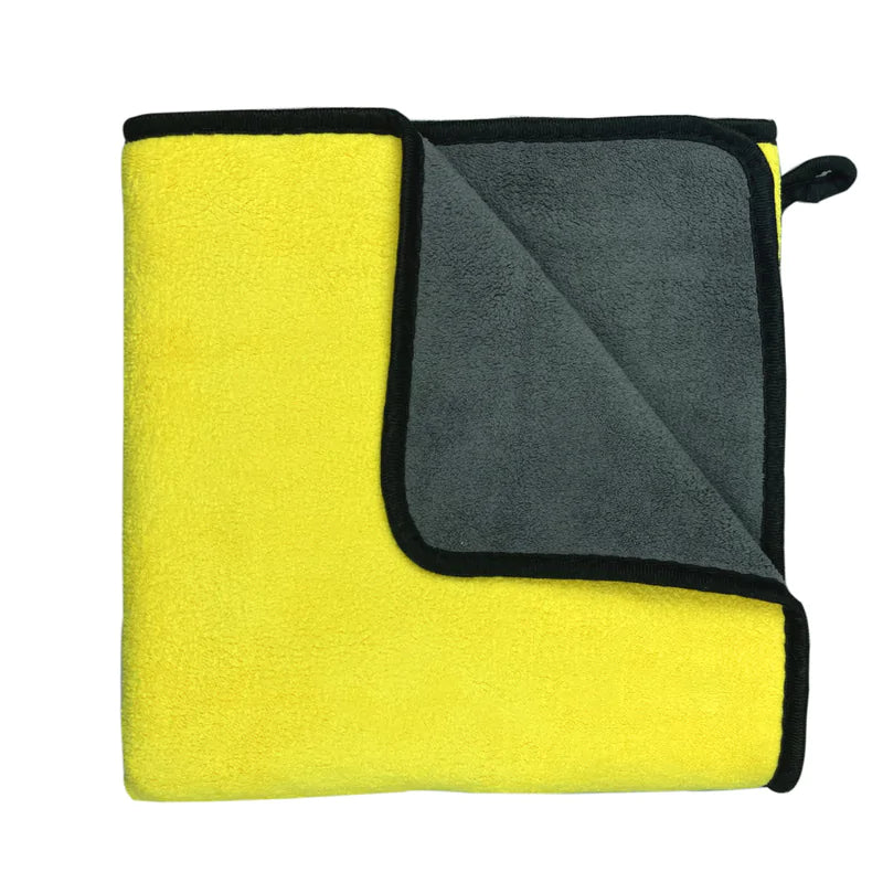 Yellow towel with reverse side showing color contrast. white background. 